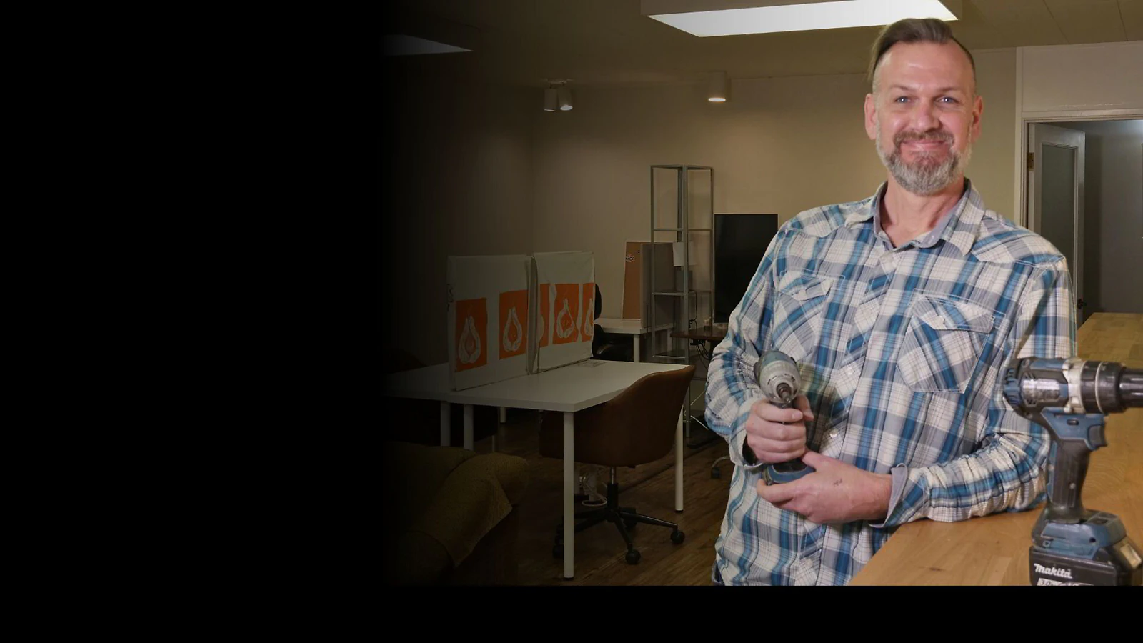 Joel from Honey-Do Hero holding power drills
